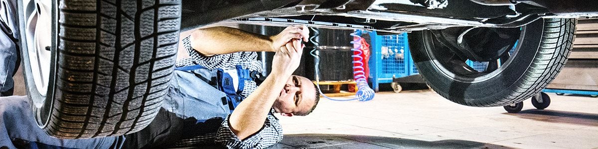 Platinumwerks Collision Center Mechanic working underneath vehicle